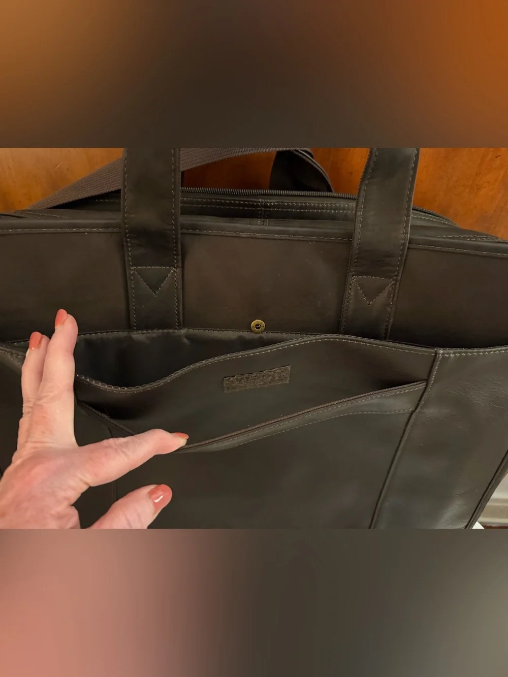 Wilson Leather dark brown leather expandable multi pocket laptop travel bag.